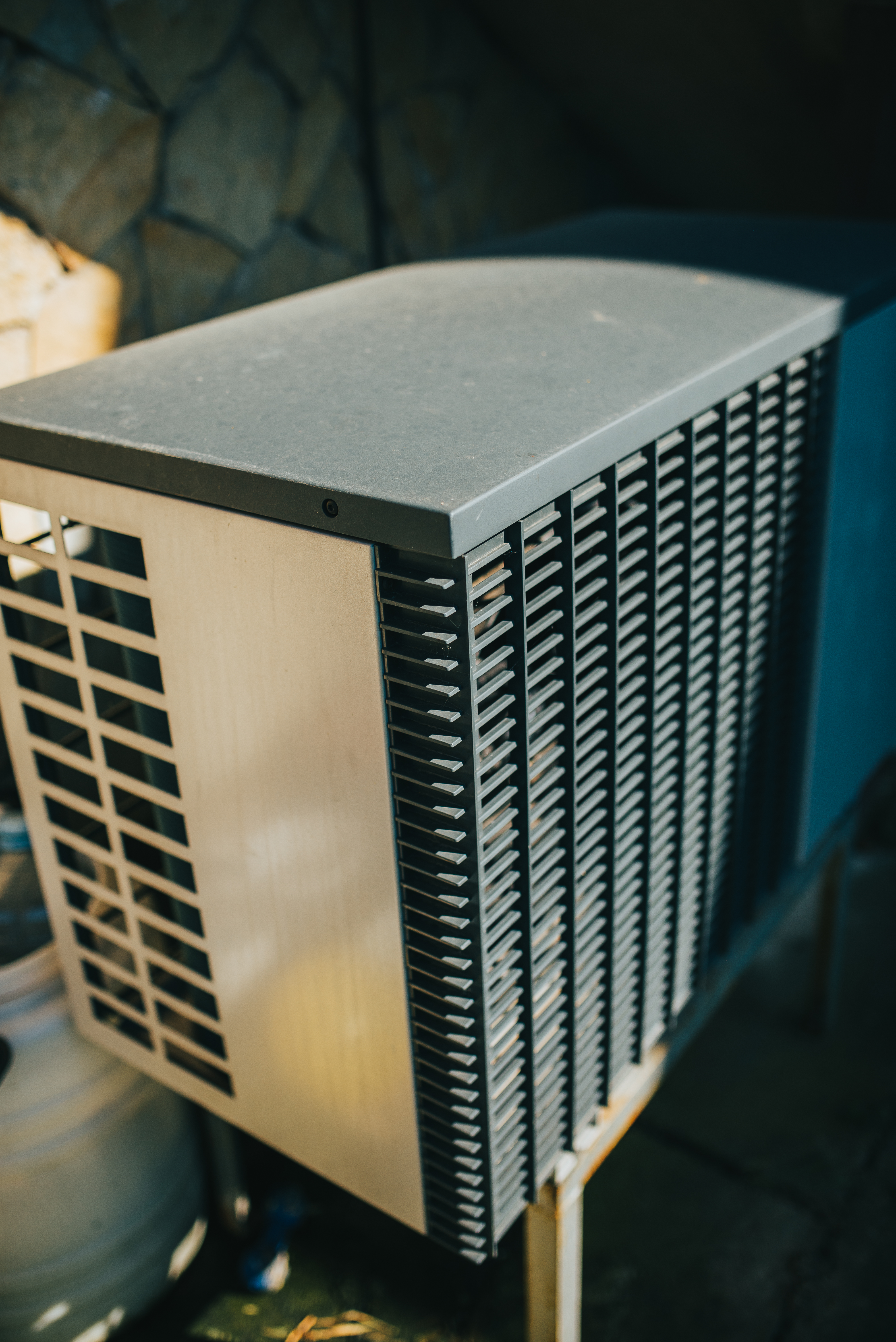 Residential mini-split outdoor condenser installed in a landscaped side yard
